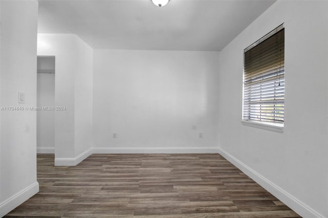 empty room with wood finished floors and baseboards