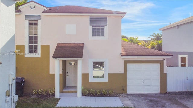 view of front of property with a garage and stucco siding