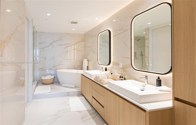 bathroom with shower with separate bathtub, vanity, and tile walls