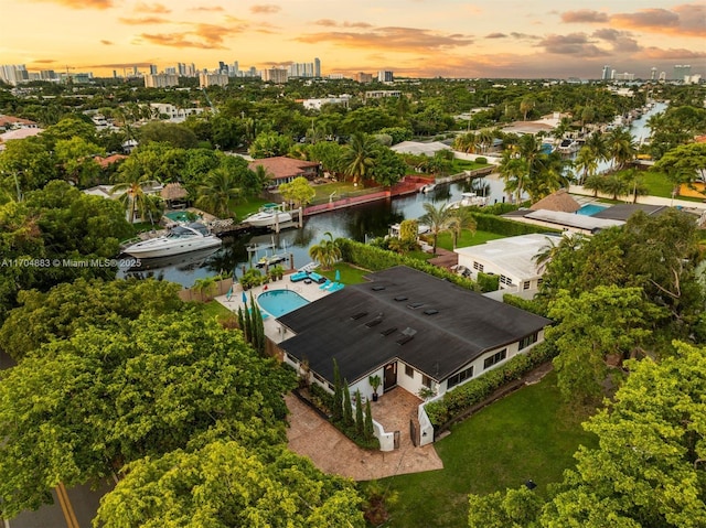 birds eye view of property featuring a water view and a city view