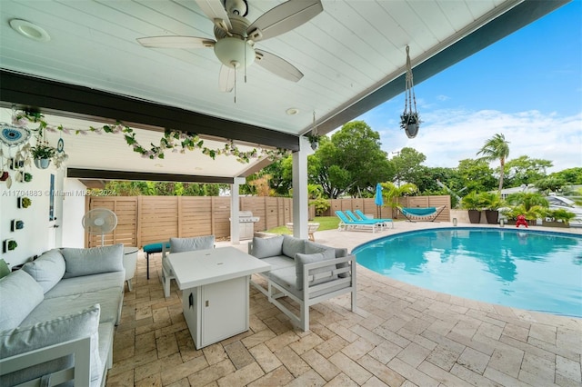 view of swimming pool featuring an outdoor living space, ceiling fan, and a patio area