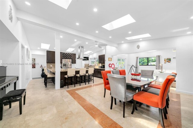 dining space featuring vaulted ceiling and ceiling fan