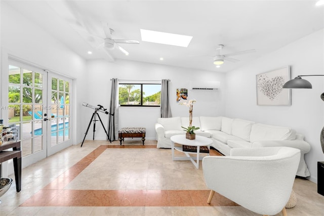 living room featuring vaulted ceiling with skylight, ceiling fan, and french doors