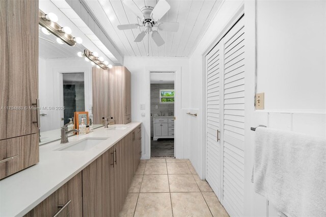 bathroom featuring tile patterned flooring, vanity, and ceiling fan