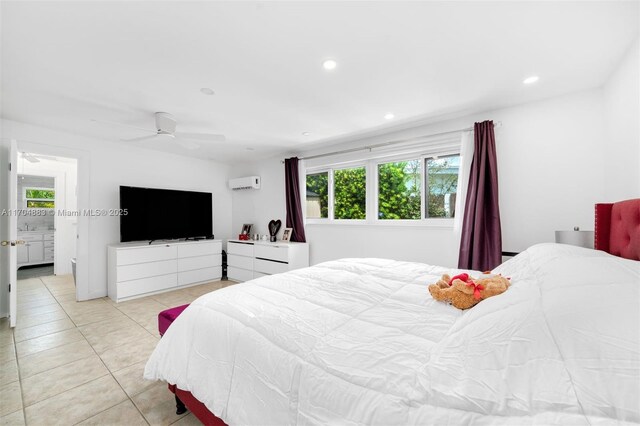 bedroom with light tile patterned floors, a wall unit AC, and ceiling fan