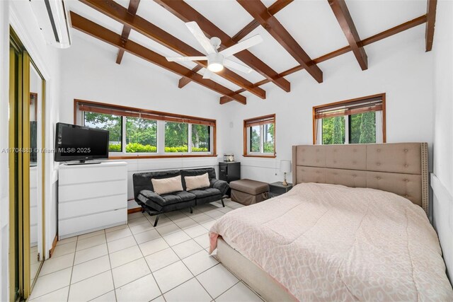 bedroom featuring vaulted ceiling with beams, ceiling fan, and light tile patterned floors