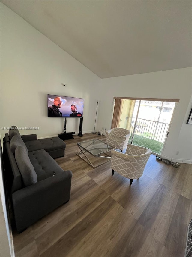 living room featuring hardwood / wood-style flooring and lofted ceiling