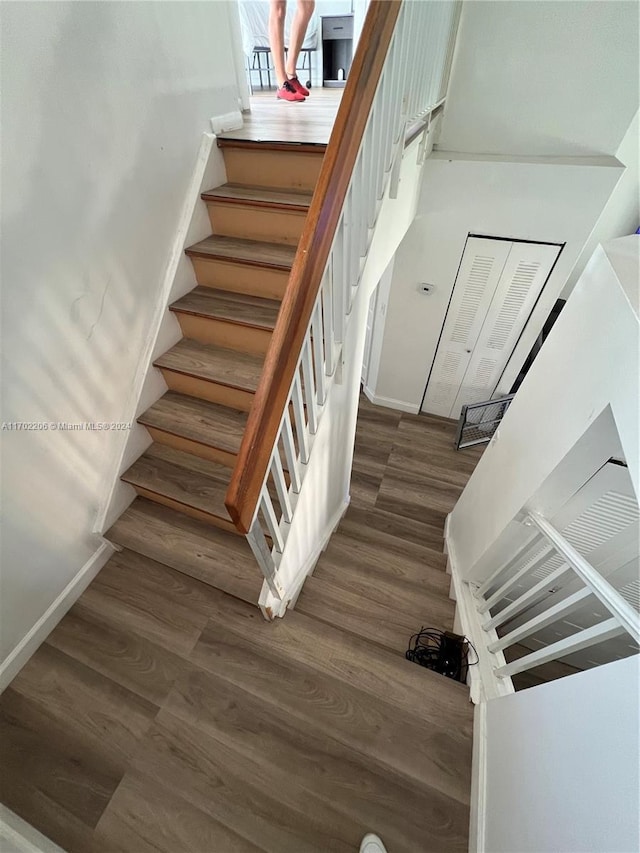 stairs featuring wood-type flooring