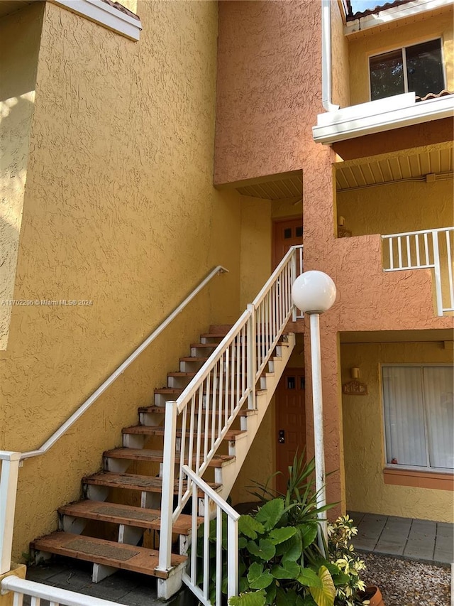 stairway featuring a high ceiling