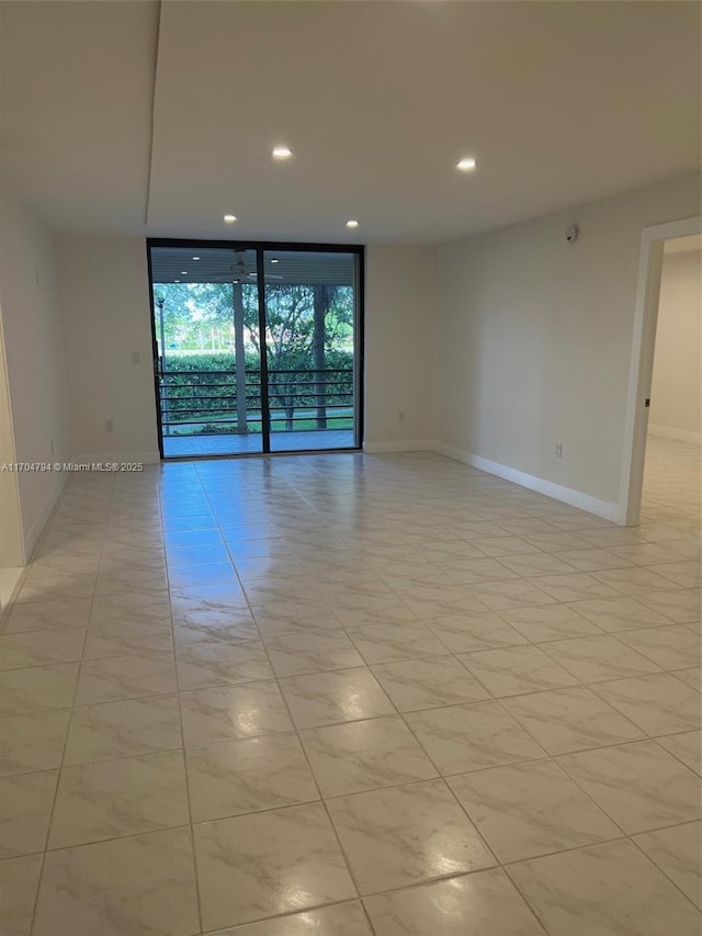 spare room featuring a wall of windows