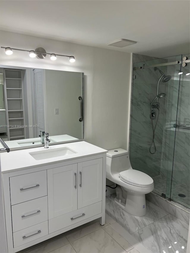 bathroom with vanity, toilet, and a shower with shower door