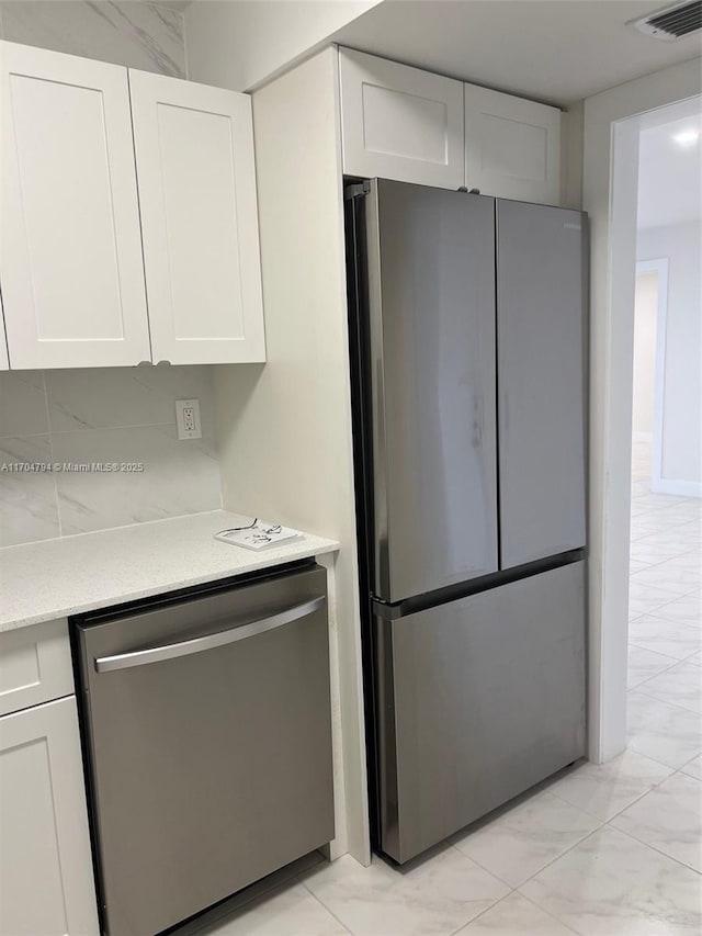 kitchen featuring white cabinetry and stainless steel appliances