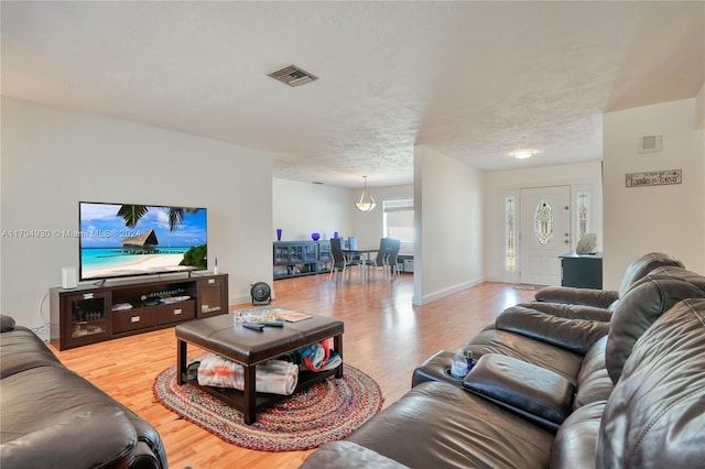 living room with wood-type flooring and a textured ceiling