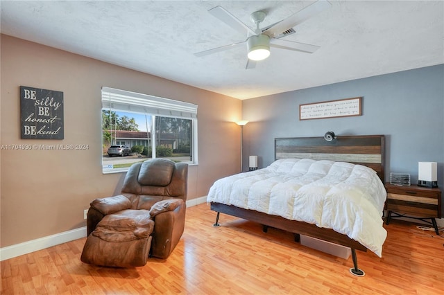 bedroom with ceiling fan and wood-type flooring