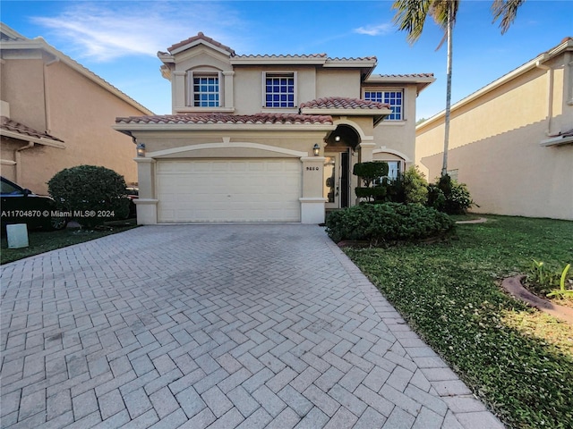 mediterranean / spanish-style home with a garage