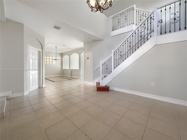 interior space with a notable chandelier and light tile patterned floors