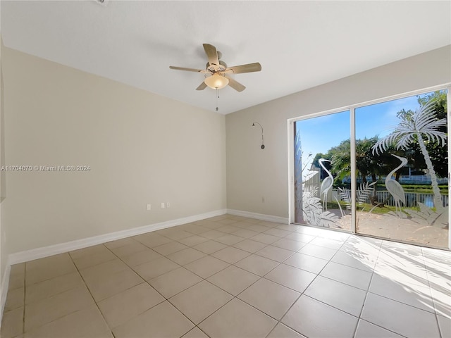 tiled empty room with ceiling fan