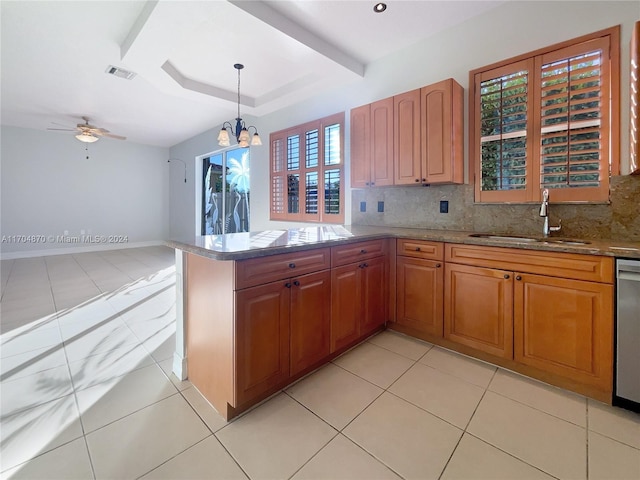 kitchen featuring ceiling fan with notable chandelier, decorative light fixtures, backsplash, and sink