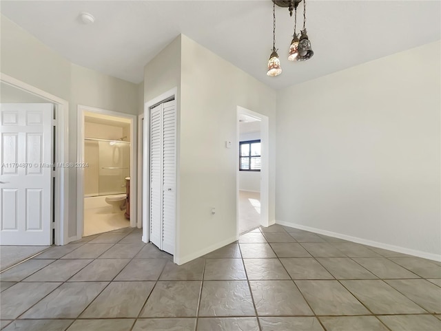 interior space with tile patterned floors and an inviting chandelier