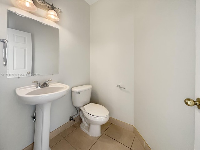 bathroom featuring tile patterned flooring and toilet