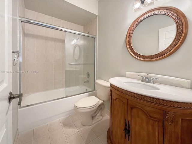 full bathroom featuring tile patterned floors, vanity, toilet, and enclosed tub / shower combo