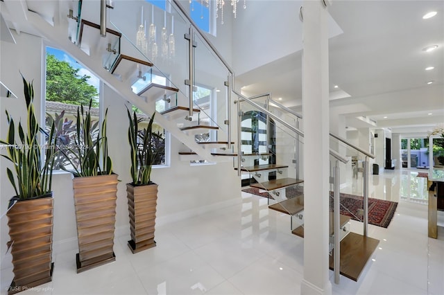 stairs with tile patterned floors and a healthy amount of sunlight