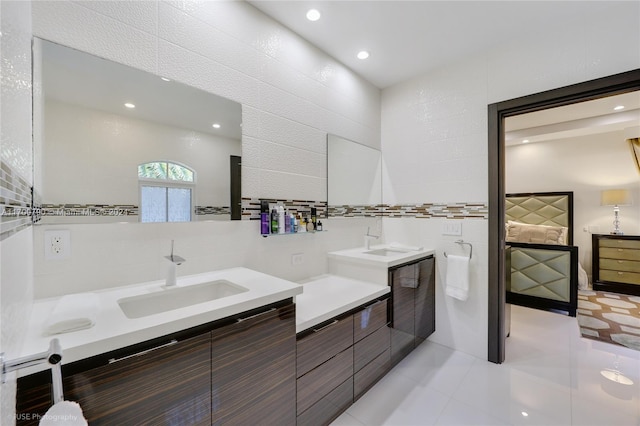 bathroom featuring tile patterned floors, vanity, and tile walls