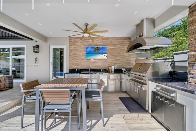 view of patio with ceiling fan, a grill, exterior kitchen, and sink