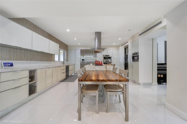 dining area featuring light tile patterned floors and sink