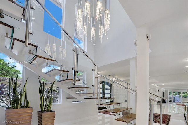 stairway with an inviting chandelier