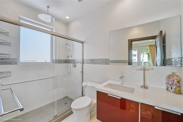 bathroom featuring backsplash, vanity, toilet, and walk in shower