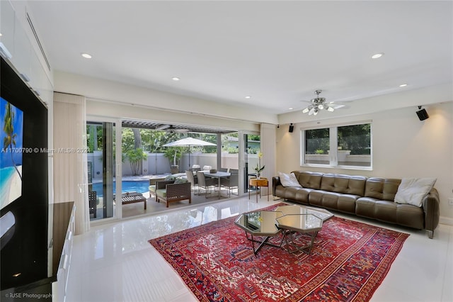 living room featuring ceiling fan and light tile patterned floors