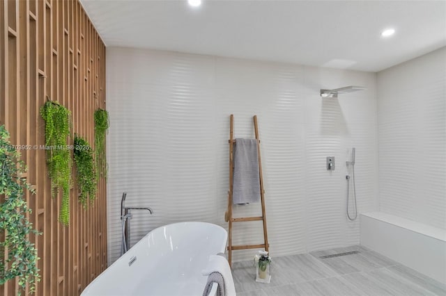 full bath featuring a shower, a soaking tub, and recessed lighting
