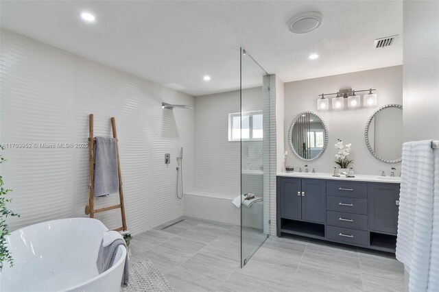 bathroom featuring tile patterned flooring, vanity, and separate shower and tub