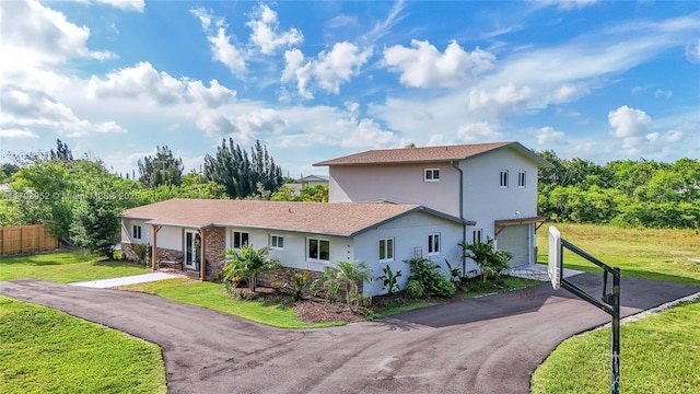 19450 SW 125th Ave, Miami, FL 33177 - view of front of house with an attached garage, stucco siding, and driveway