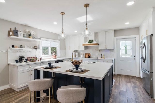 19450 SW 125th Ave, Miami, FL 33177 - kitchen featuring freestanding refrigerator, decorative backsplash, light countertops, a center island, and dark wood-style floors