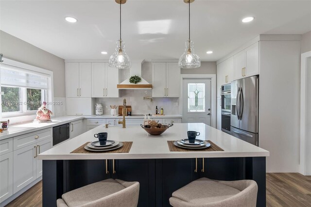 19450 SW 125th Ave, Miami, FL 33177 - kitchen with appliances with stainless steel finishes, light countertops, a breakfast bar area, backsplash, and recessed lighting