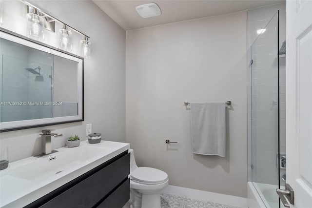 bathroom featuring tile patterned flooring, vanity, toilet, and a tile shower