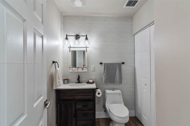 bathroom featuring hardwood / wood-style floors, vanity, and toilet