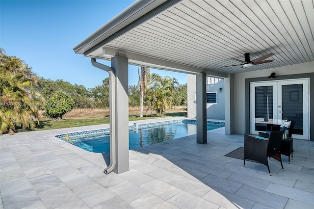 outdoor pool with a ceiling fan, french doors, and a patio