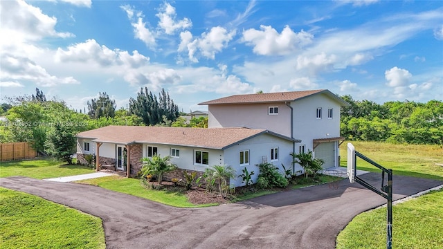 view of front of property with a garage and a front yard