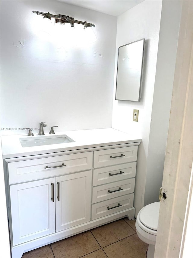 bathroom featuring tile patterned floors, vanity, and toilet