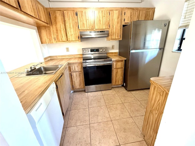 137 NW 93rd Ave Unit 103, Pembroke Pines, FL 33024 - kitchen featuring appliances with stainless steel finishes, extractor fan, light tile patterned floors, and a sink