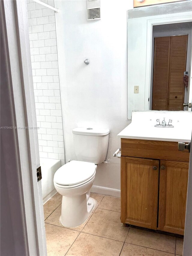 137 NW 93rd Ave Unit 103, Pembroke Pines, FL 33024 - full bathroom featuring vanity, toilet, tile patterned flooring, baseboards, and shower / tub combination