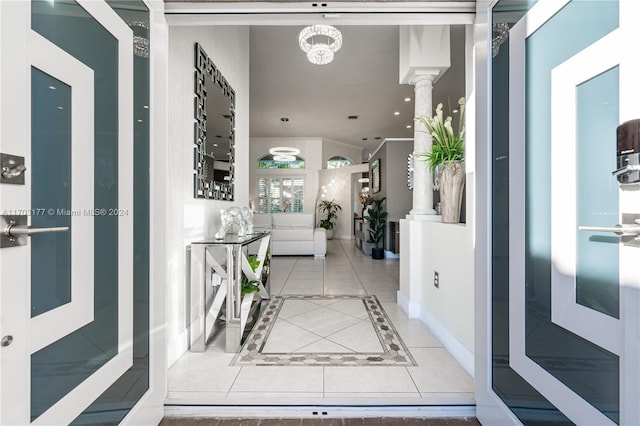 hall with ornate columns and tile patterned flooring