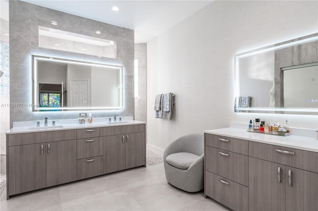 bathroom with vanity and tile walls