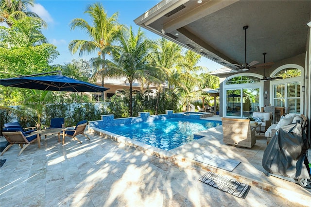 view of pool with ceiling fan and a patio