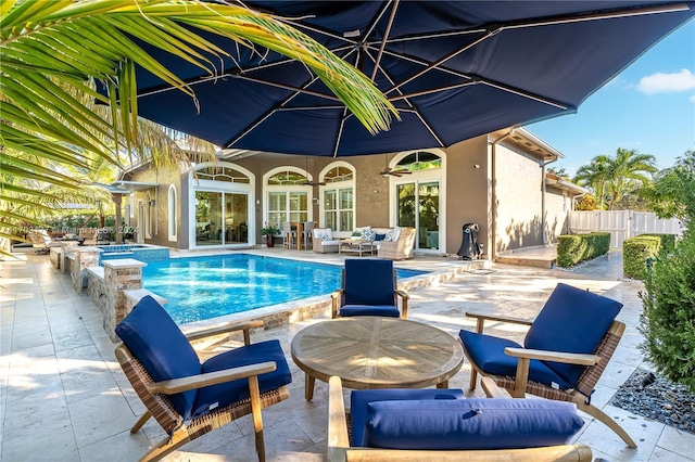 view of swimming pool featuring a patio area, an outdoor hangout area, and an in ground hot tub