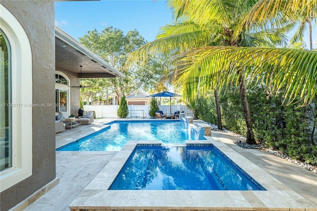 view of swimming pool with a patio area and an in ground hot tub