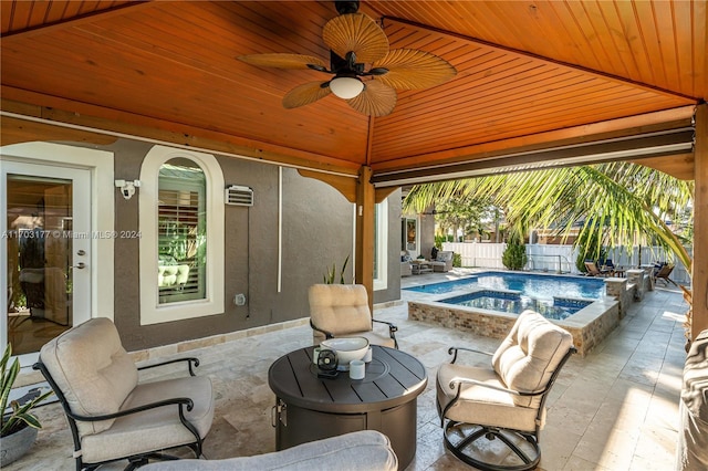 view of patio with a gazebo, ceiling fan, and a pool with hot tub